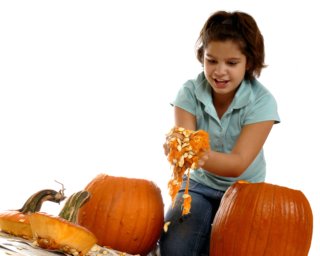 Child  cleaning out pumpkin seeds.