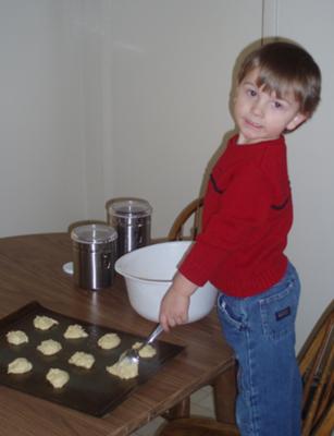 my son spooning batter onto cookie sheet